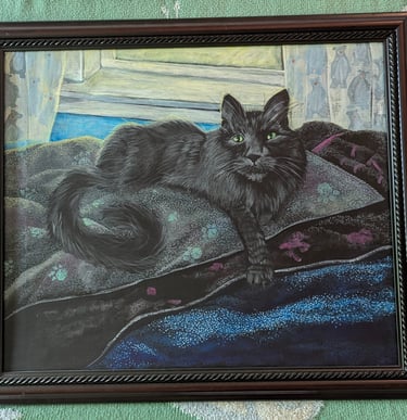 Cherry oak framed arcrylic portrait painting of a long haired black cat with very green eyes laying in his blanketed bean bag
