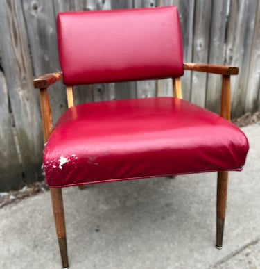 red vinyl vintage chair with edge damage