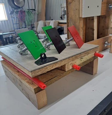 Mounted color-coded anchor plates displayed on a construction test setup for framing and insulation systems