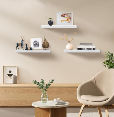 White floating shelves displaying plants, books, and modern home decor accessories