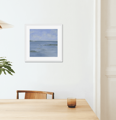 a table with a vase and a vase with a plant in it