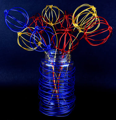 Abstract wire sculpture of flowers in a vase