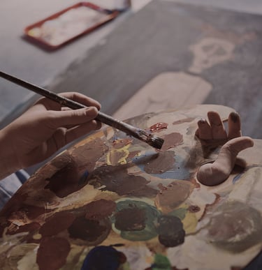 Photo of an artist painting a picture