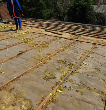 Old tile roof stripped down, showing deteriorated battens and perished underlay on a West Rand roof