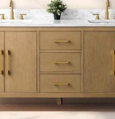 Light oak wood double bathroom vanity with a white marble top and gold hardware.