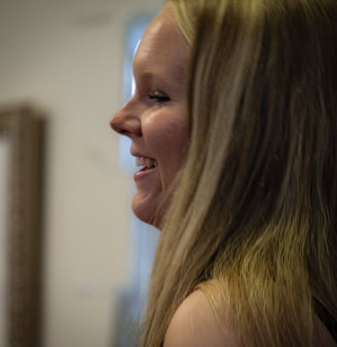 Side profile of a happy blonde woman with long hair smiling at her Senior Party Athens Ohio