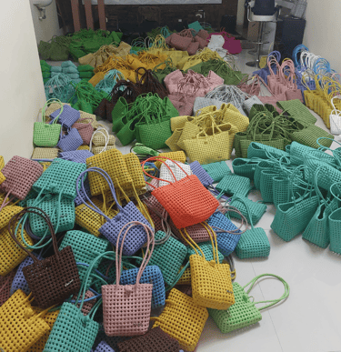 Bulk collection of handmade woven plastic bags ready for wholesale export by Craftvitas Indonesia.