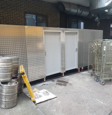 timber built smoking shelter and barrel store