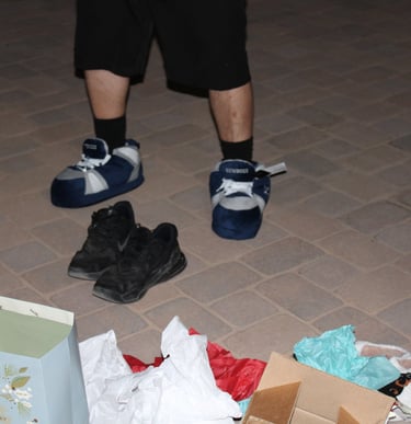 a person standing in front of a box of shoes