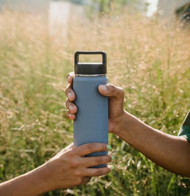 Two friends sharing a reusable water bottle