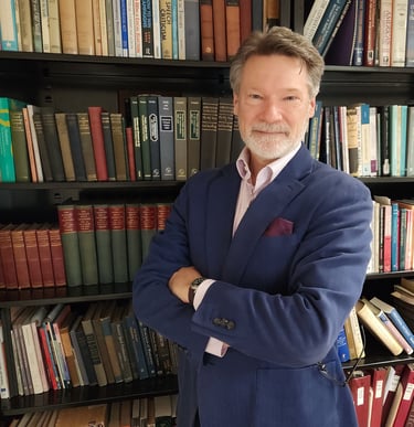 J. Andrew Kuypers by bookcase