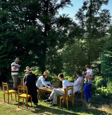 a group of people sitting in the garden have a fun.B&B and Small Hotel Consulting with Timea Pokol