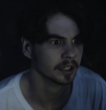 a man with a beard and a white shirt