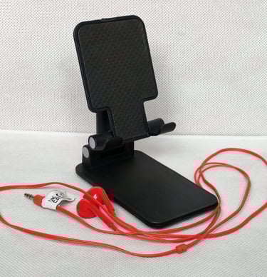 Desk phone holder, foldable, with a red, wired earphones, to make the sessions more comfortable
