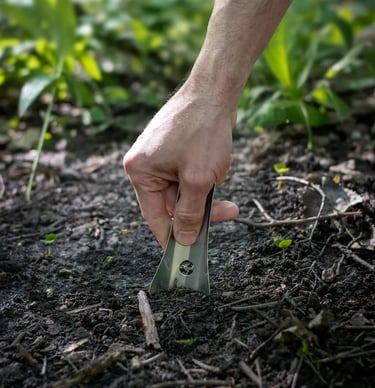 Hand pushing boglerco trowel into ground