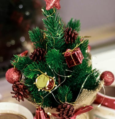 Tabletop mini Christmas trees with burlap bases and fairy lights on a shelf for simple holiday décor