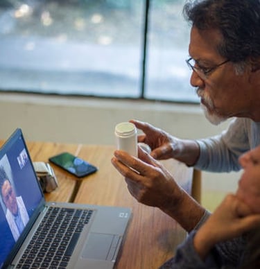 a man and woman sitting at a table with a cup of coffee, virtual therapy