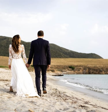 Editorial fine art wedding photo of bride and groom walking on a South of France beach