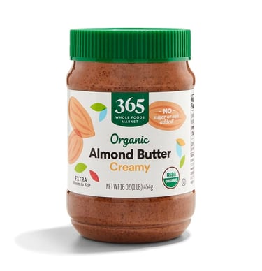 A 16 oz jar of 365 Whole Foods Market Creamy Organic Almond Butter with a green lid and no sugar or salt added.