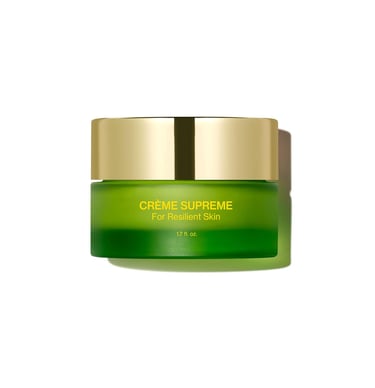 A green glass jar of Crème Supreme facial moisturizer for resilient skin with a gold lid.