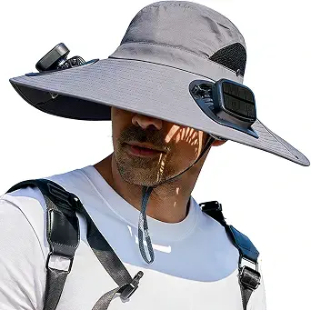 A man wearing a grey wide-brimmed sun hat with built-in solar-powered cooling fans.