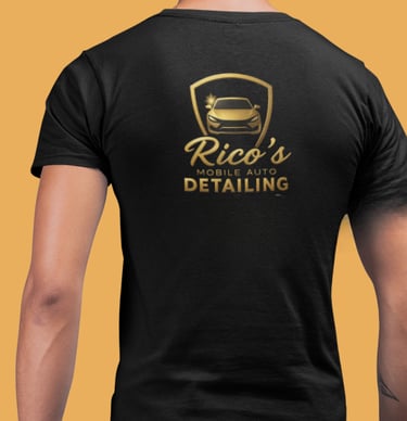 a man wearing a black shirt with a gold plated logo on it