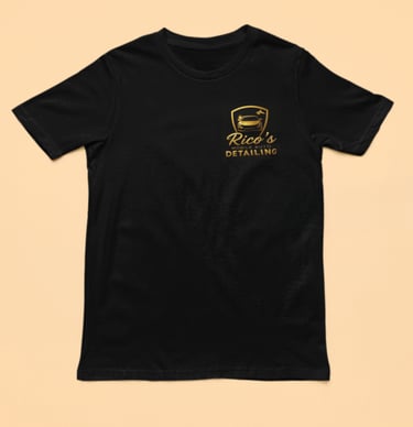 a black t - shirt with a gold foiled logo on the front