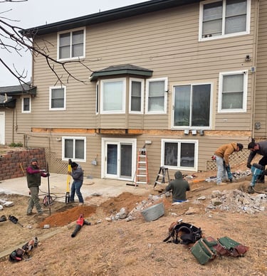 Construction site preparation and initial framing for a large-scale residential deck project.