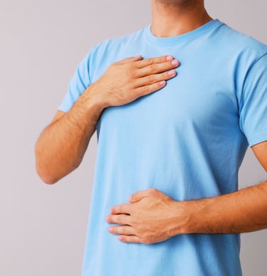 a man with a chest pain holding his chest
