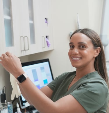 Dental hygienist reviewing patient for a cleaning in a dental office