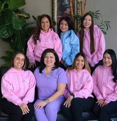 Dental care team posing together in a professional dental office in Manhattan and Queens, New York