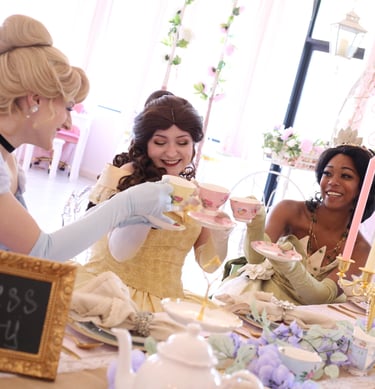 Tiana, Belle, and Cinderella cheers with tea cups
