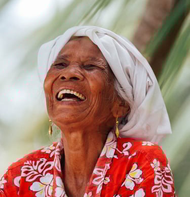 Smiling Mentawai local woman in traditional attire, embodying the warmth of island culture.