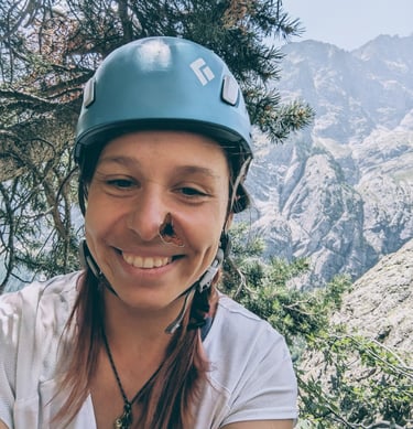 a woman in a helmet on a mountain