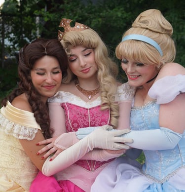 Belle, Cinderella, and Aurora share a hug