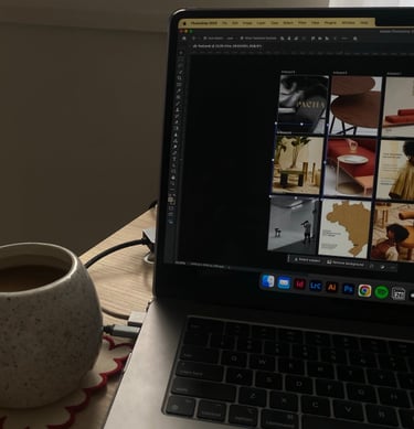 a laptop computer sitting on a table with a cup of coffee