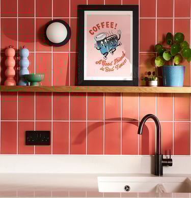 Glossy coral wall tiles with white grout in a modern kitchen splashback, featuring pastel pink