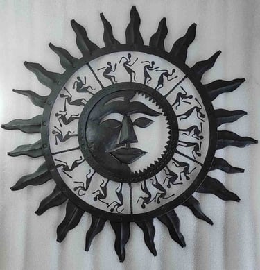 "Handcrafted iron wall art featuring sun face and dancing tribal figures–Bastar decor-for global markets"