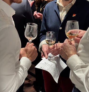 Wine tasting experience London guests sampling wine with sommelier