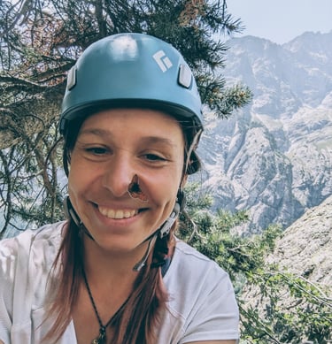 a woman in a helmet on a mountain