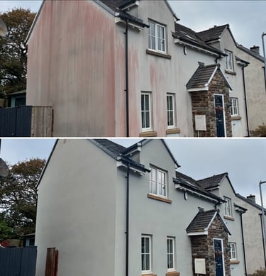Render cleaning on a house in Lincoln using soft washing and chemical treatment to remove stains