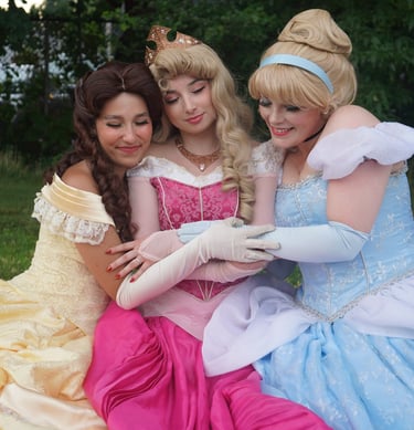 Belle, Cinderella, and Aurora share a hug