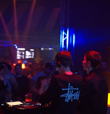 a dj spinning around in a nightclub