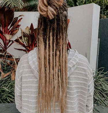 a woman with long hair and dreadlocks on her head