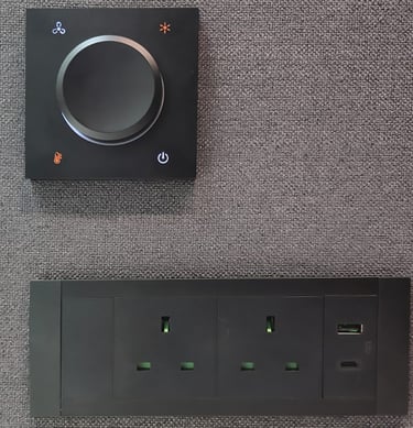 Power outlet panel with dial switch on felt wall