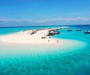 A stunning aerial view of Nakupenda Sandbank in Zanzibar, Tanzania, showcasing pristine white sand, turquoise waters