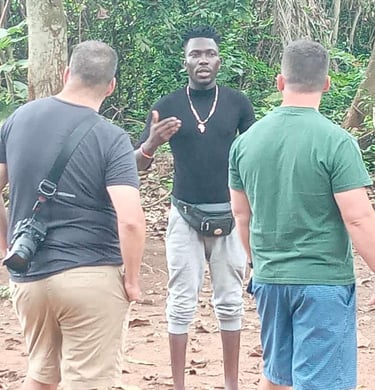 Dahomey African Tours Guide leading Tourists in the Sacred Forest in Ouidah in Benin