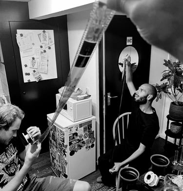 Youth inspecting their developed film negatives.
