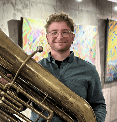 Christian Bidwell-Thompson holding his tuba
