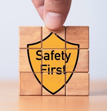 Building blocks with the graphic of a yellow shield saying "Safety First" on the front
